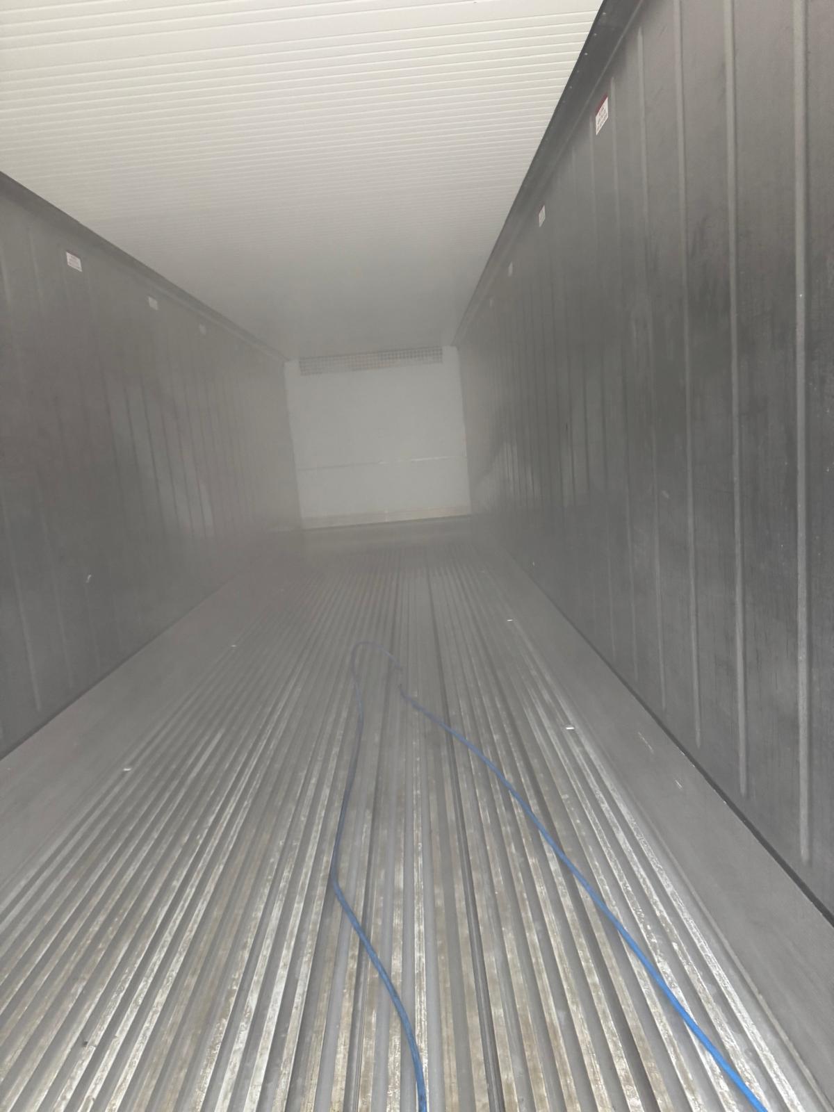 Steam cleaning inside reefer container in progress
